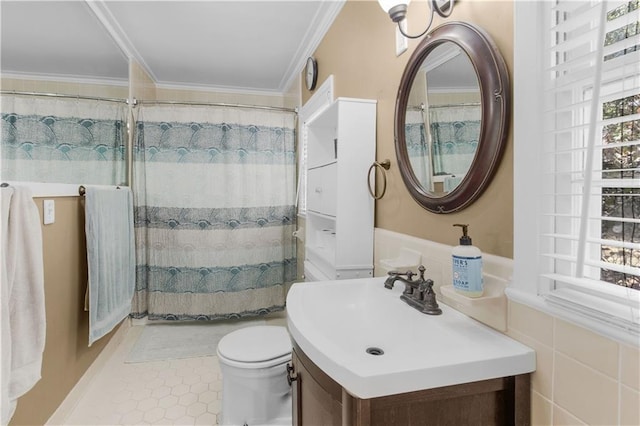 bathroom featuring tile patterned flooring, toilet, tile walls, vanity, and crown molding