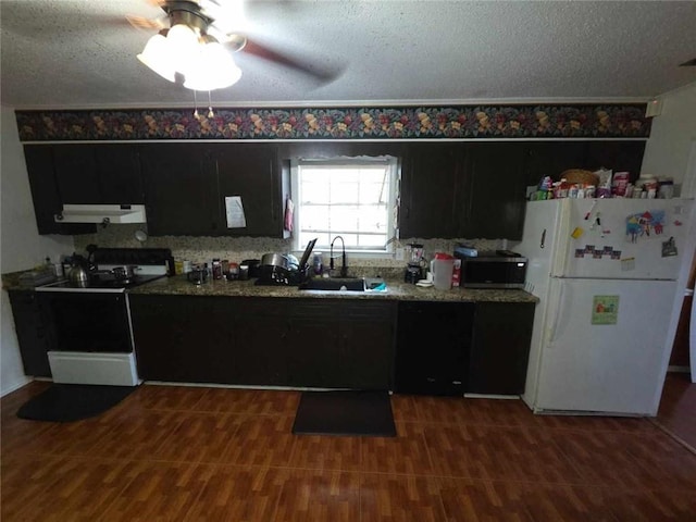 2460 Maple Dr, Mobile, AL 36695 - kitchen featuring freestanding refrigerator, under cabinet range hood, electric stove, stainless steel microwave, and a textured ceiling