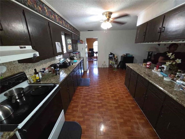 2460 Maple Dr, Mobile, AL 36695 - kitchen with black electric range, under cabinet range hood, ceiling fan, a textured ceiling, and freestanding refrigerator