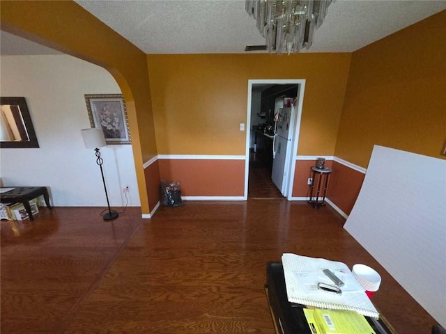 2460 Maple Dr, Mobile, AL 36695 - unfurnished dining area featuring a chandelier, wood finished floors, and arched walkways