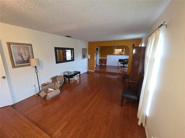2460 Maple Dr, Mobile, AL 36695 - corridor with wood finished floors, a textured ceiling, and arched walkways
