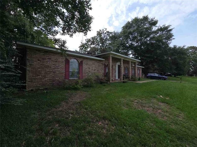 2460 Maple Dr, Mobile, AL 36695 - view of property exterior with a yard and brick siding