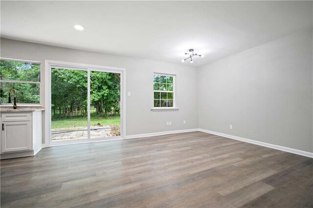 1513 Carlisle Dr W, Mobile, AL 36618 - unfurnished living room with a chandelier, baseboards, wood finished floors, and recessed lighting