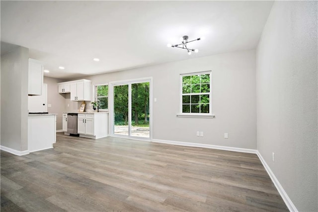 1513 Carlisle Dr W, Mobile, AL 36618 - unfurnished living room featuring plenty of natural light, baseboards, wood finished floors, and recessed lighting
