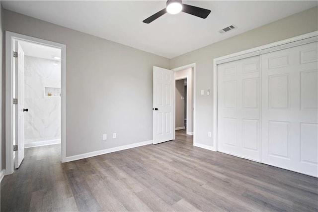 1513 Carlisle Dr W, Mobile, AL 36618 - unfurnished bedroom with wood finished floors, a closet, baseboards, a ceiling fan, and ensuite bath