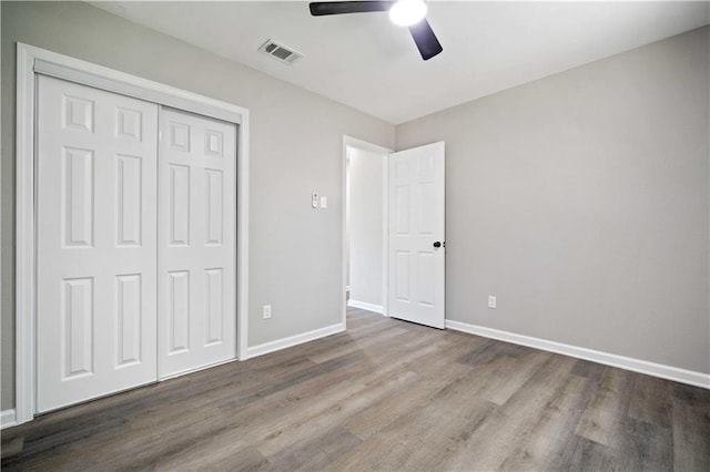 1513 Carlisle Dr W, Mobile, AL 36618 - unfurnished bedroom featuring wood finished floors, baseboards, a closet, and ceiling fan
