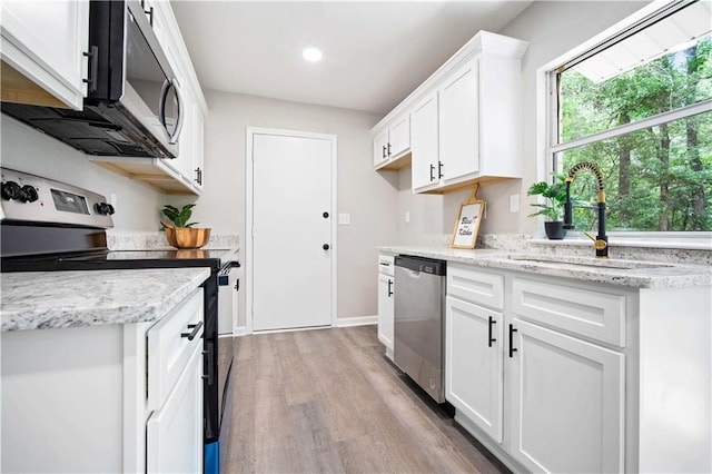 1513 Carlisle Dr W, Mobile, AL 36618 - kitchen with appliances with stainless steel finishes, a sink, light wood-style flooring, white cabinetry, and light stone countertops