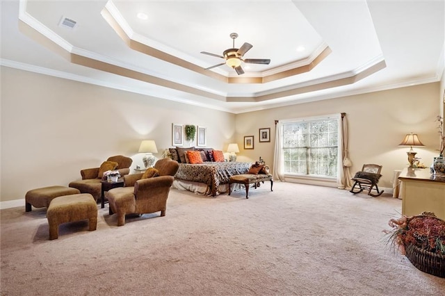 carpeted bedroom with a raised ceiling, ceiling fan, and crown molding