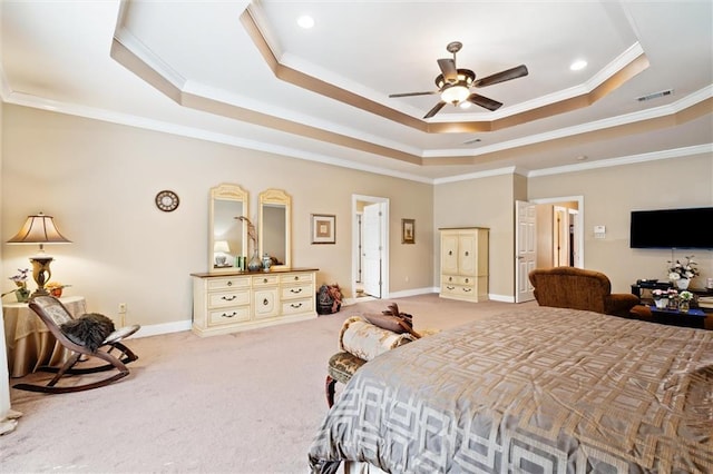 bedroom featuring ceiling fan, carpet floors, crown molding, and a tray ceiling