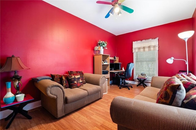 living room featuring ceiling fan and light hardwood / wood-style flooring