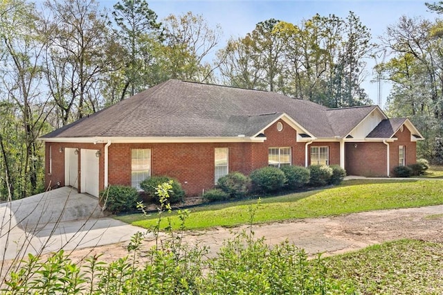 ranch-style home featuring a garage and a front lawn