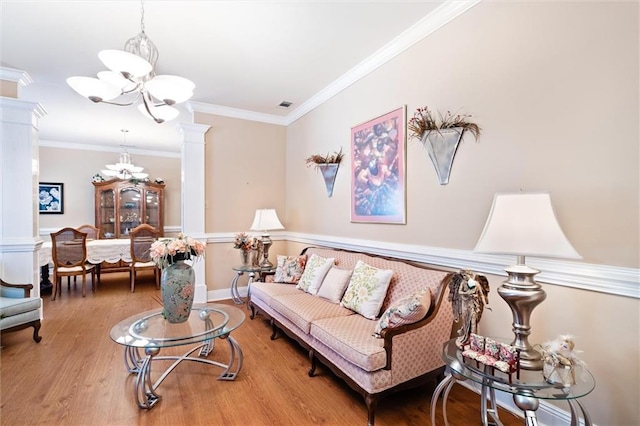 living room with crown molding, a chandelier, and wood-type flooring