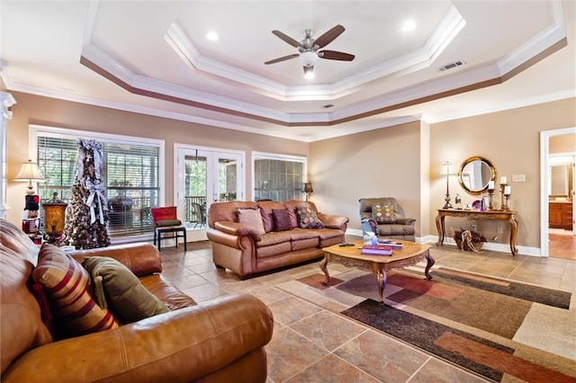 living room featuring a tray ceiling, ceiling fan, french doors, and ornamental molding