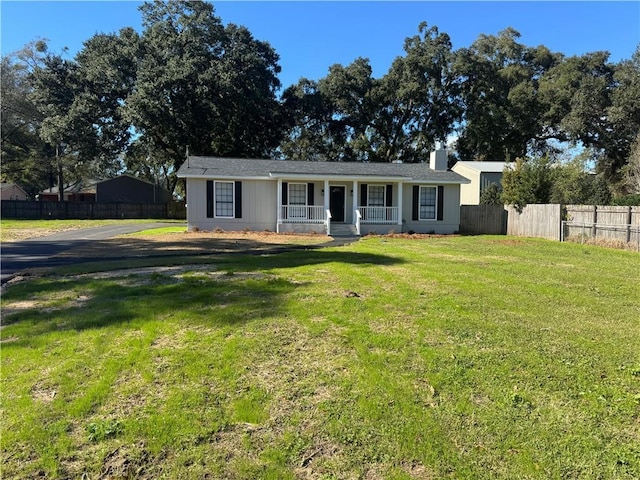 ranch-style home with covered porch and a front lawn