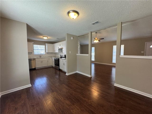 kitchen featuring plenty of natural light, stainless steel appliances, sink, and white cabinets