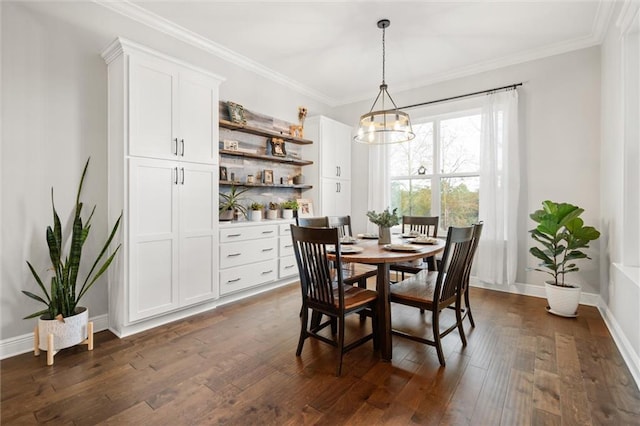 dining area with dark hardwood / wood-style flooring, crown molding, and an inviting chandelier