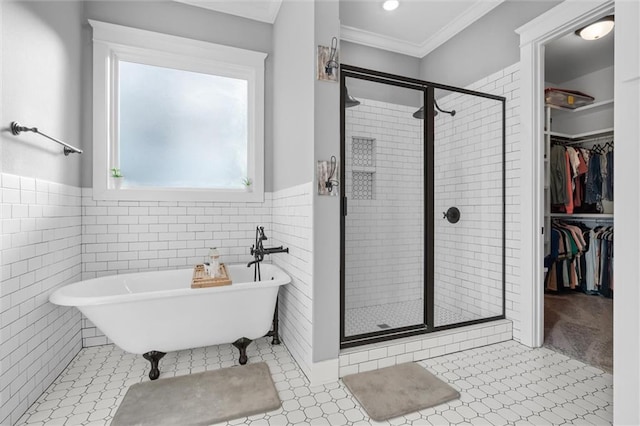 bathroom with ornamental molding, independent shower and bath, and tile walls