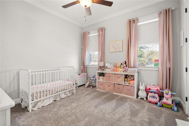 bedroom with a crib, crown molding, carpet, and multiple windows