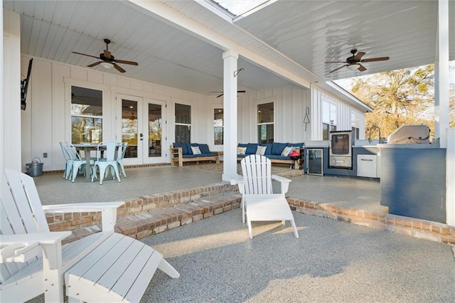 view of patio featuring grilling area, outdoor lounge area, ceiling fan, and french doors