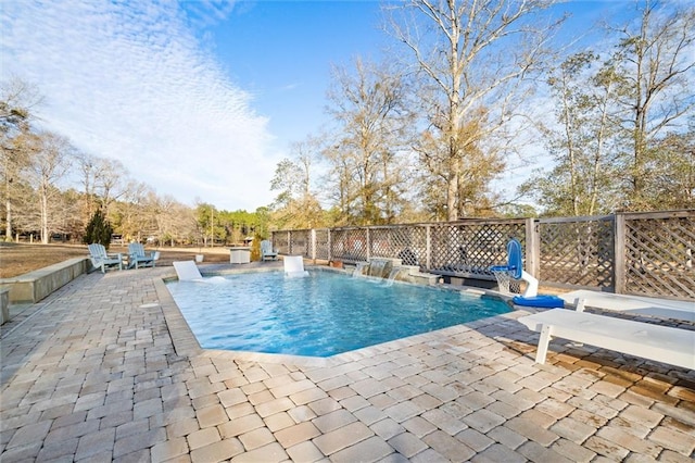 view of pool with pool water feature and a patio