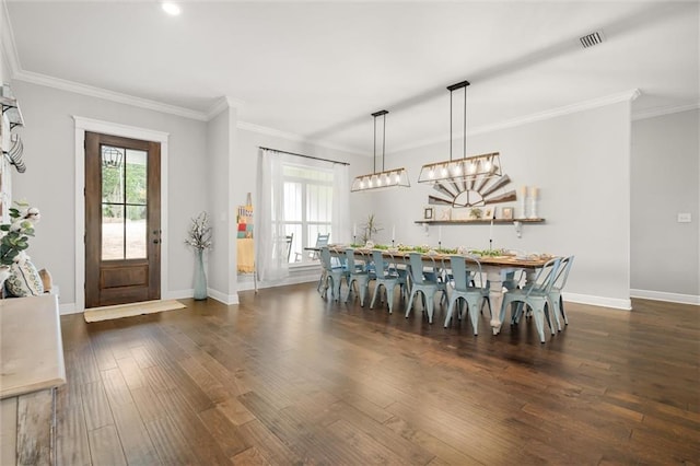 dining area featuring crown molding and dark hardwood / wood-style flooring