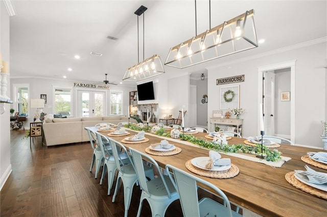 dining space featuring dark wood-type flooring and crown molding