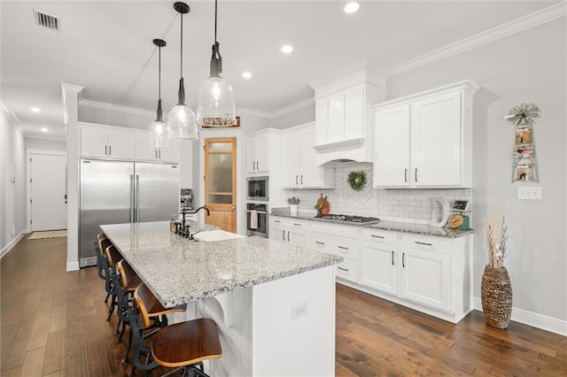 kitchen featuring white cabinetry and a center island with sink