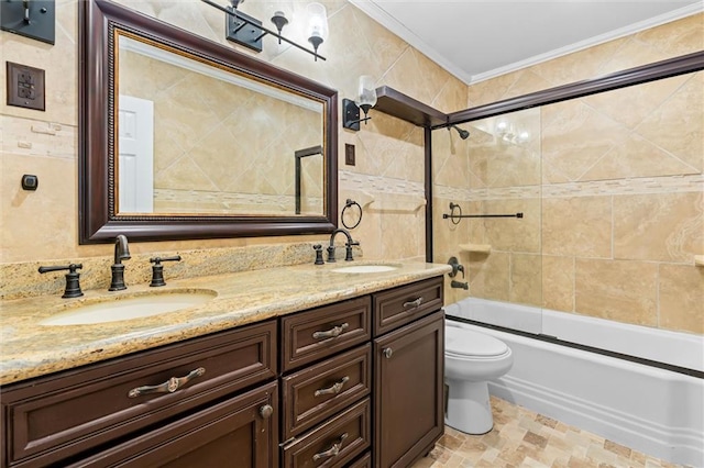 full bathroom featuring combined bath / shower with glass door, toilet, tile walls, vanity, and ornamental molding