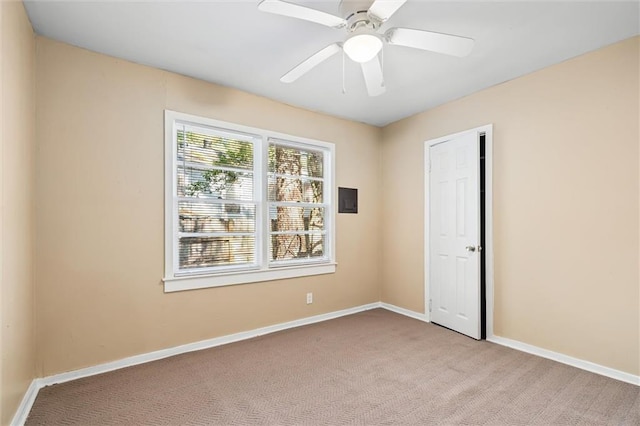 empty room featuring ceiling fan and light colored carpet