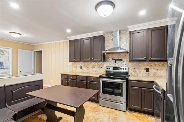 kitchen with wall chimney exhaust hood, stainless steel appliances, crown molding, dark brown cabinetry, and light tile patterned floors