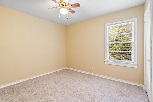 carpeted spare room with ceiling fan