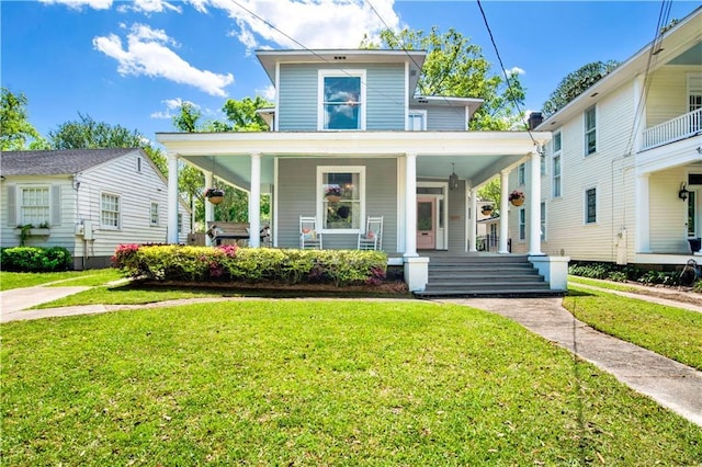 view of front of house featuring covered porch and a front yard