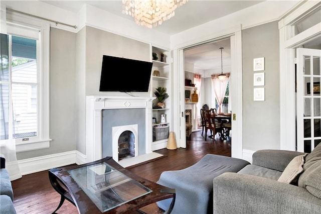 living room with a chandelier, wood finished floors, and a wealth of natural light