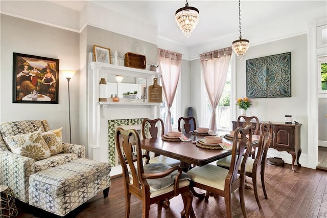 dining space featuring baseboards, a chandelier, and dark wood finished floors