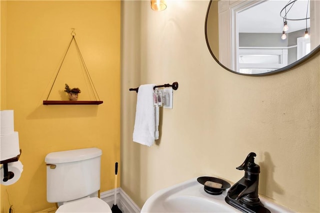 half bathroom with a sink and toilet