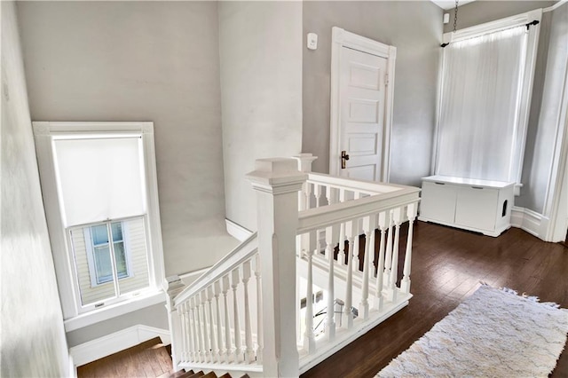 stairs with wood-type flooring and baseboards