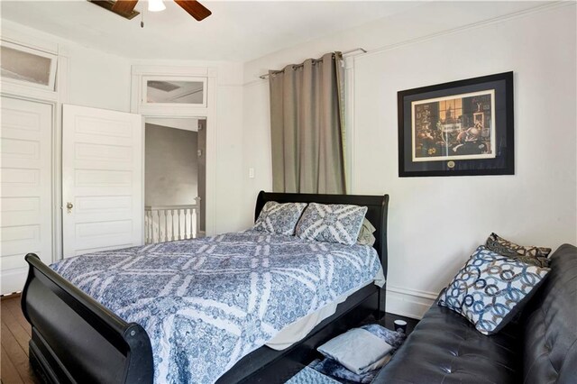 bedroom featuring wood finished floors, ceiling fan, and baseboards
