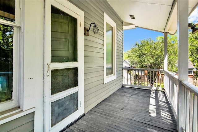 wooden deck featuring visible vents