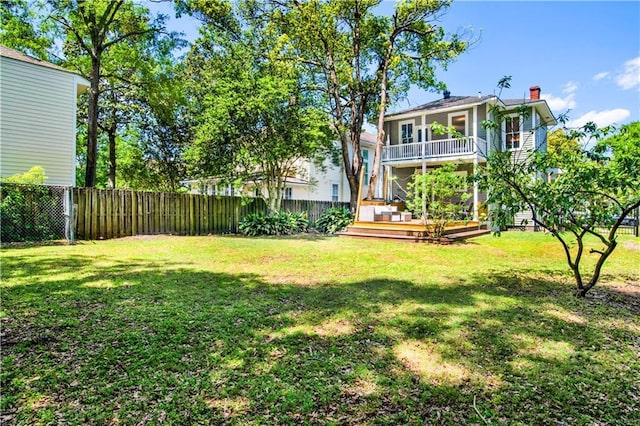view of yard with a fenced backyard and a wooden deck