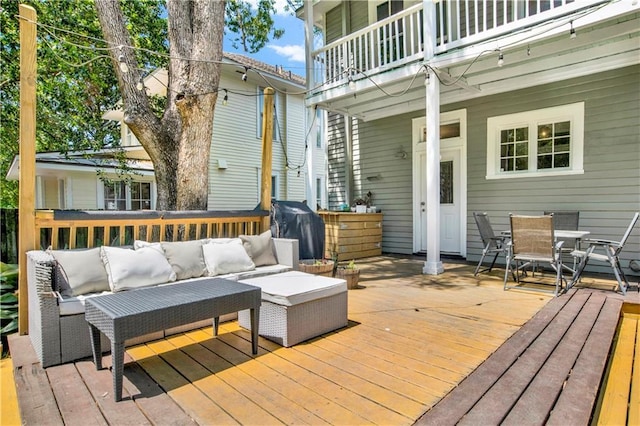 wooden terrace featuring an outdoor living space, a grill, and outdoor dining area