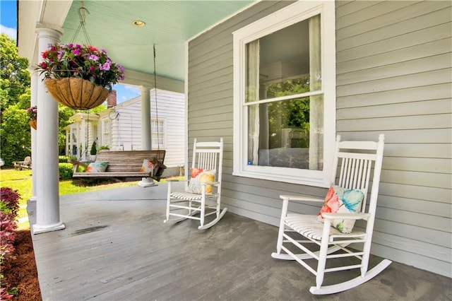 wooden terrace with a porch