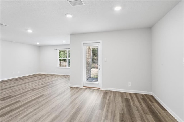 spare room with hardwood / wood-style flooring