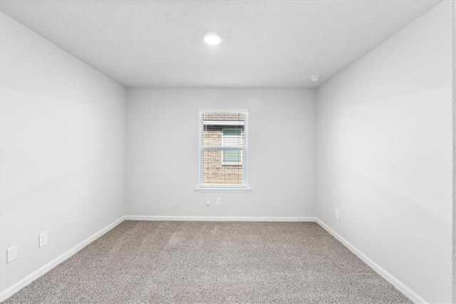 unfurnished room featuring carpet flooring