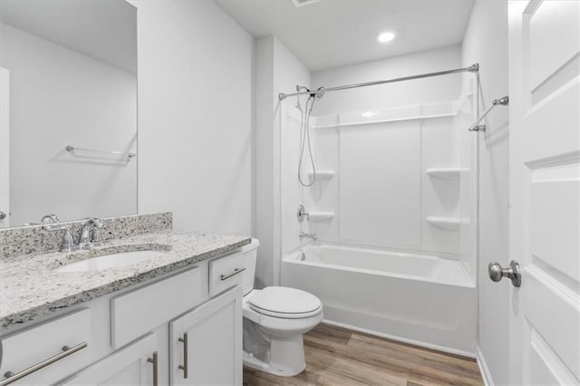 full bathroom featuring shower / bathing tub combination, hardwood / wood-style floors, vanity, and toilet