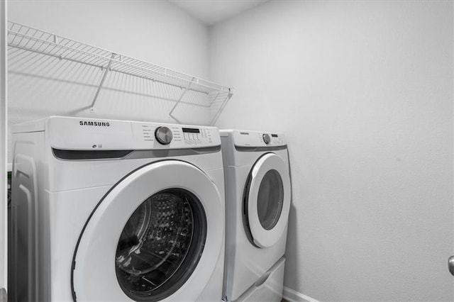 clothes washing area featuring washer and clothes dryer