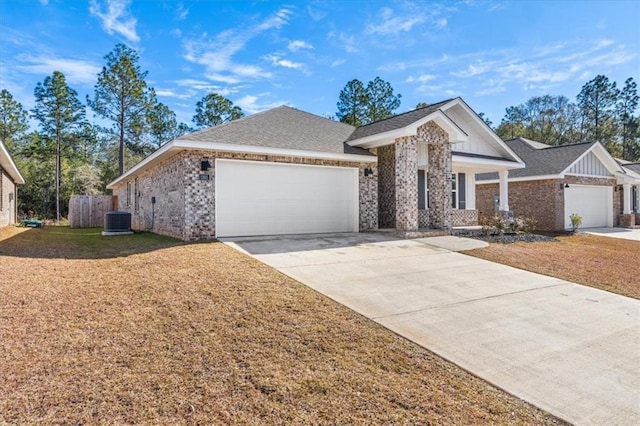 ranch-style house with a front lawn, central AC, and a garage