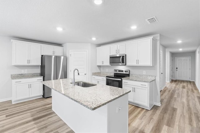 kitchen with sink, white cabinets, an island with sink, and appliances with stainless steel finishes