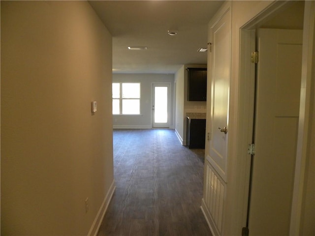 hallway with dark hardwood / wood-style flooring