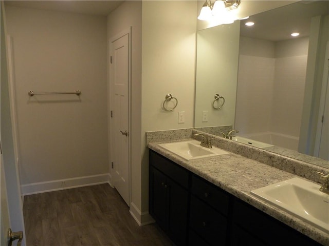 bathroom featuring vanity, a bath, and hardwood / wood-style flooring