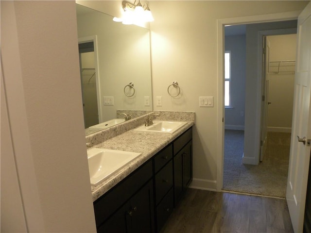 bathroom with hardwood / wood-style floors, vanity, and an inviting chandelier